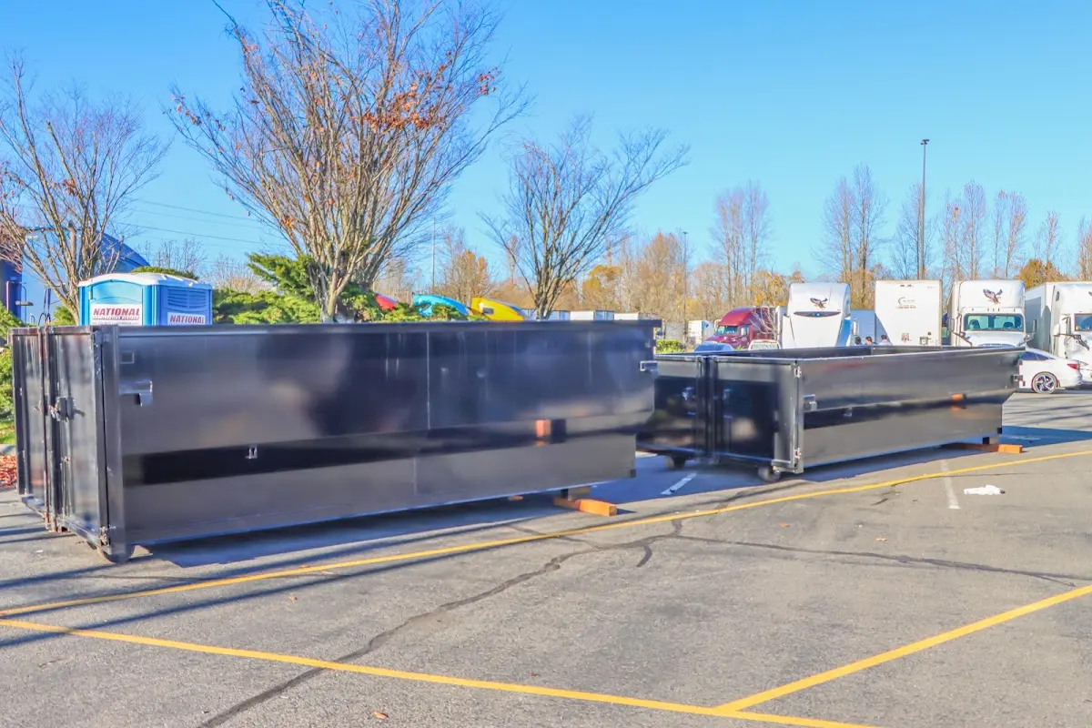 Professional dumpster rental service with roll-off container on residential driveway in Abington